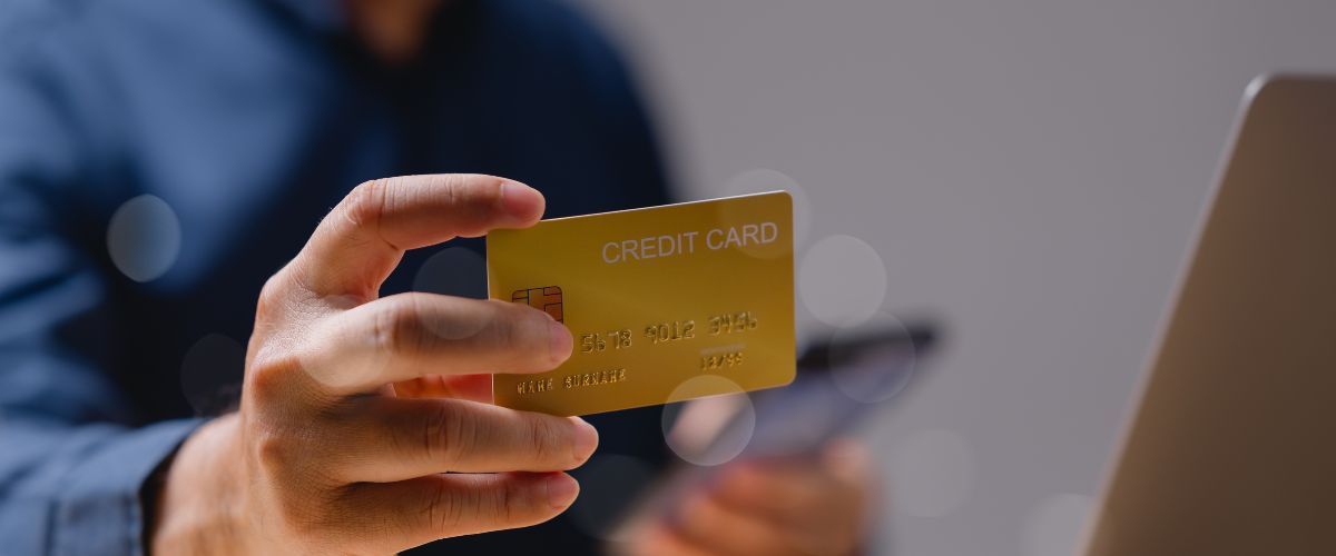 close up of a man purchasing SaaS software using a credit card