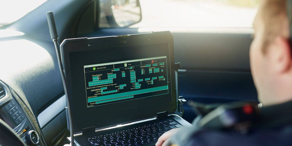 interior of a police cruiser with officer using public safety application