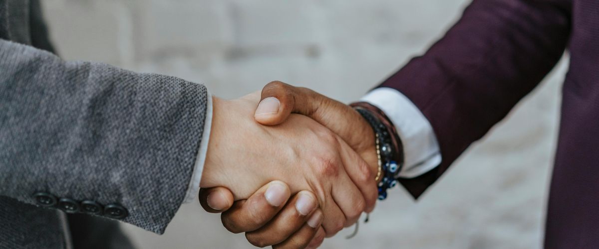 closeup of two men shaking hands